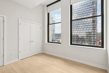 A room with a large window and a view of a cityscape.